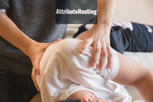 Crop anonymous medical specialist rubbing shoulders of male client lying on couch in medical salon