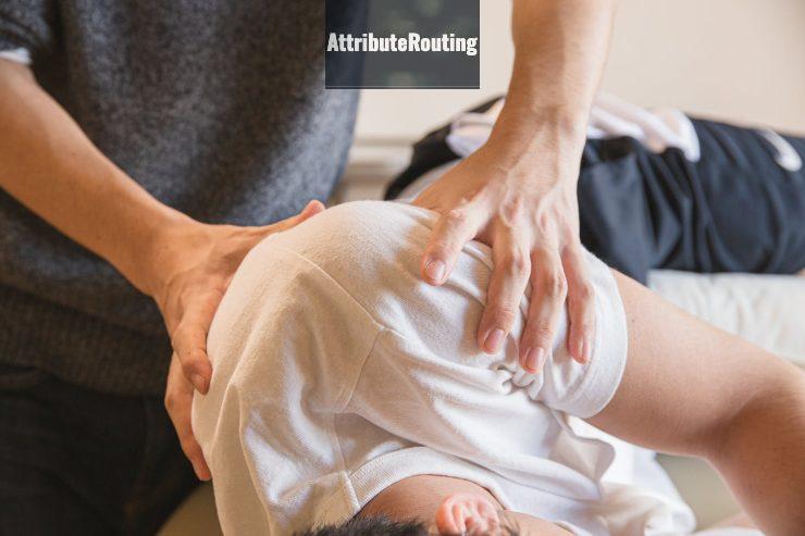 Crop anonymous medical specialist rubbing shoulders of male client lying on couch in medical salon