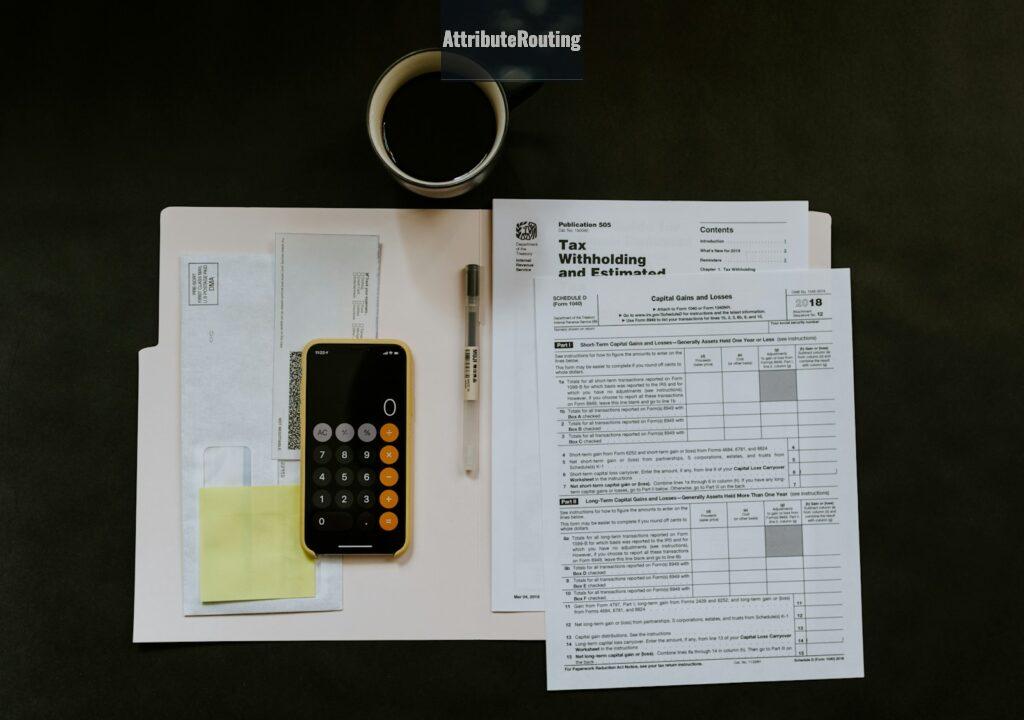 black Android smartphone near ballpoint pen, tax withholding certificate on top of white folder